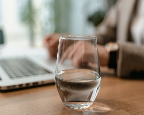 Close up of a glass of water on a desk